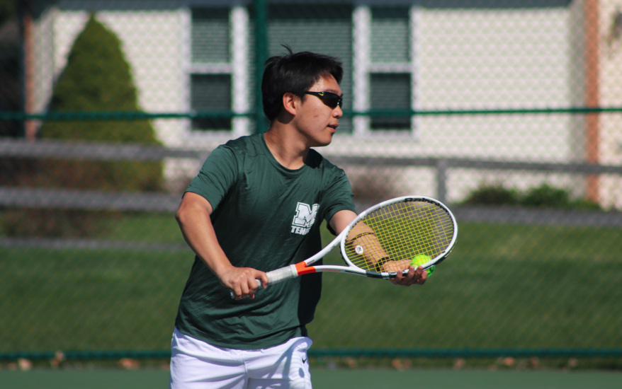 boy serving ball